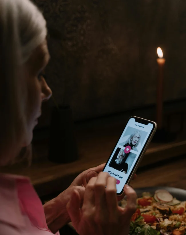 a woman using a dating app on her phone